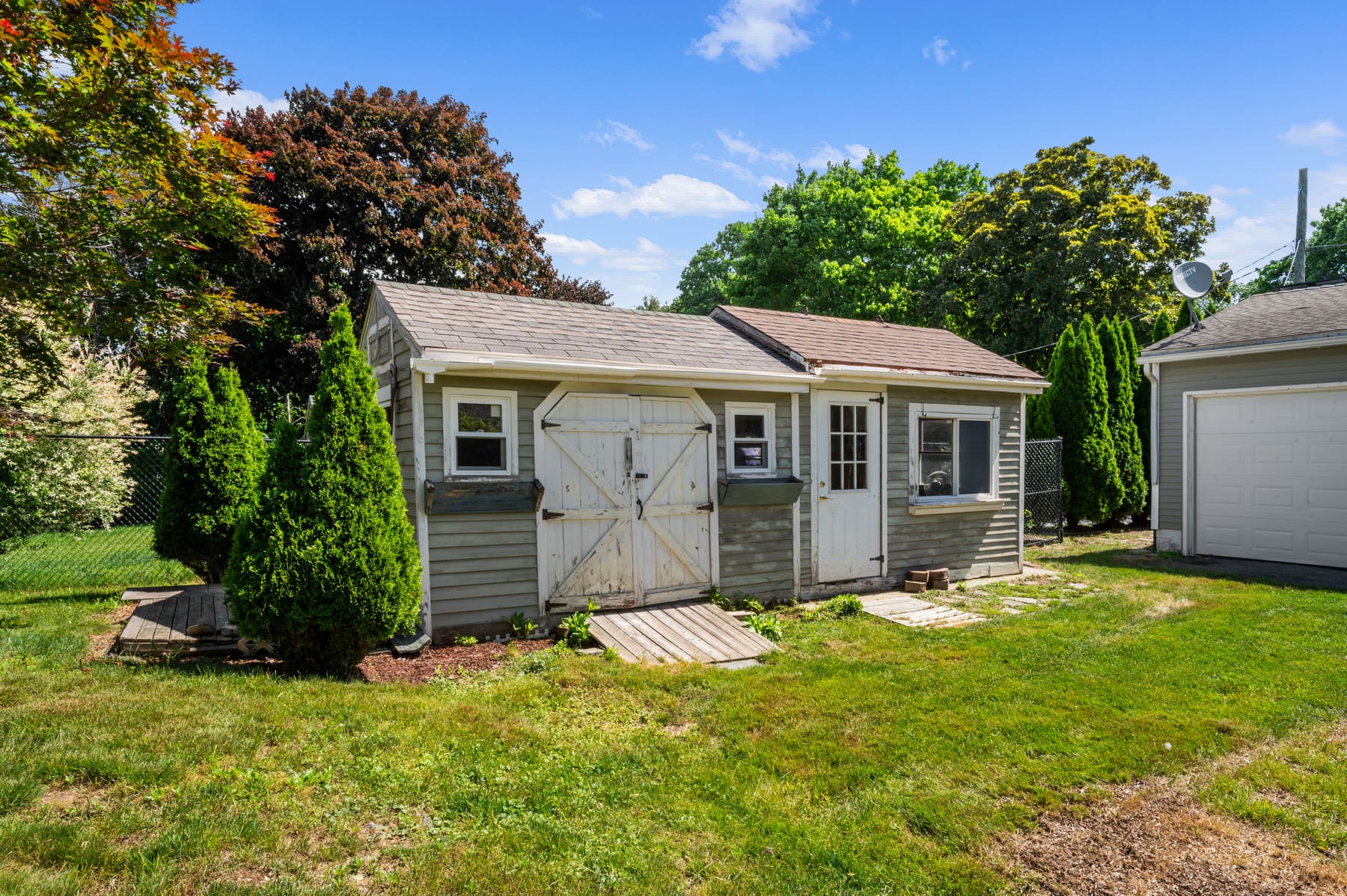 Backyard with lawn and storage sheds